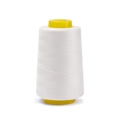 Macro view of white 402 polyester sewing thread on yellow plastic core spool - Approx 100g / Off-White