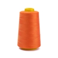 Close-up of bright orange 402 polyester sewing thread on yellow plastic cone core - Approx 100g / Orange