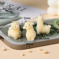 Macro view of cute flocked alpaca charm showing exact dimensions on a phone case - Yellow Alpaca