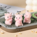 Macro detail of pink flocked pig pendants for DIY crafts showing precise dimensions - Drink Pig