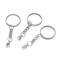 Detail of three silver metal keychains with large rings, short chains and lobster clasps - White K/Silver