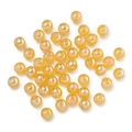 Detail of yellow iridescent round acrylic beads with holographic finish for DIY crafts - Light Orange