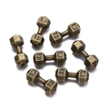 Macro shot of antique bronze dumbbell spacer beads with Live and Lift engravings - Ancient Bronze