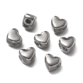 Detailed view of heart-shaped stainless steel spacer beads with polished surface and holes - 5 Pieces / Silver Heart