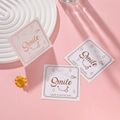 Square greeting card with Smile text and gold stars on a pink background - Smile Style