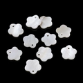 Flat lay of 10 white mother of pearl flower beads with single hole for DIY jewelry - Plum Blossom (Large)