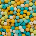 Macro shot of 6mm matte finish acrylic beads with center holes for DIY craft jewelry - Lake Blue Yellow Series