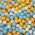 Macro shot of 6mm matte finish acrylic beads in assorted colors for DIY jewelry making - Yellow And Blue