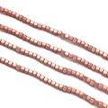 Macro shot of 2-4mm rose gold hematite cube beads for DIY necklace jewelry making - Matte Rose Gold