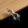 Detailed macro view of a mini bulb-shaped clear glass wishing bottle with cork and metal ring - Round Ball with Eyelet Cork Stopper