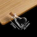 Macro view of mini heart-shaped glass bottle with dimensions 27mm height and 20.5mm width - Slanted Heart with Cork Stopper