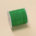 Roll of 0.4mm emerald green polyester cord for DIY jewelry and knot making - Green