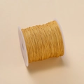 Golden 0.4mm polyester cord on white spool for DIY jewelry and braided necklaces - Light Yellow