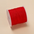 Roll of 0.4mm red polyester jade cord on spool for DIY jewelry and knot weaving - Red