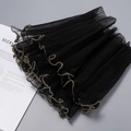 Macro detail of black pleated mesh fabric with gold wavy edge for floral gift wrapping - Black Gold Edge