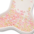 Macro view of assorted colorful ABS imitation pearls for DIY crafts in a ceramic tray - Approx. 10g/Bag (3-7.5mm) / Iridescent No Hole Artificial Pearl - Yellow Pink Series (AC4093)