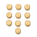 Detailed macro shot of gold polished stainless steel number beads for DIY jewelry making - Number 0 / 1 Piece / Gold