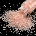 Macro view of pink iridescent crushed glass gravel pouring from a clear bottle - Orange Pink / 30ml Bottle