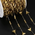 Macro detail of gold stainless steel geometric chain with triangle and bead elements - 1 Meter / Gold Triangle (Triangle Approx 6x6.5mm)