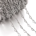 Close-up of silver hollow heart-shaped stainless steel chain on a white spool for DIY jewelry - 1 Meter / Steel Color Hollow Horizontal Heart (Heart Approx 4.5x10mm)