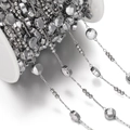 Macro shot of silver stainless steel chain with beads and sequins on a spool for DIY jewelry - Approx 6mm Round, 1 Meter / Steel