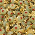 Detailed close-up of multiple green glass jade pendants with golden flower metal settings - Green Style 10 (2 Pieces/Pack)