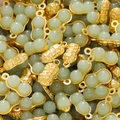 Detailed macro view of gold peanut-shaped pendants with light green faux jade beads for DIY - Green Style 11 (2 Pieces/Pack)
