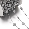 Macro detail of stainless steel chain with shell charms on a white spool for DIY jewelry - 1m / Silver Shell Style (AC4288)