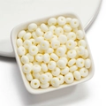 Flat round acrylic beads in cream white on a ceramic tray for DIY jewelry making - 50 Pieces/Pack (4.5x8mm) / Off-white