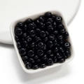Macro shot of 8mm glossy black acrylic wheel beads in a white bowl for DIY jewelry - 50 Pieces/Pack (4.5x8mm) / Black