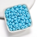 Close-up of light blue 8mm acrylic rondelle beads in a white bowl for DIY jewelry - 50 Pieces/Pack (4.5x8mm) / Blue