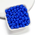 Close-up of vibrant blue acrylic spacer beads in a white bowl for DIY jewelry making - 50 Pieces/Pack (4.5x8mm) / Dark Blue
