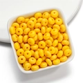 Macro detail of bright yellow acrylic disc beads in a white bowl for jewelry making - 50 Pieces/Pack (4.5x8mm) / Yellow