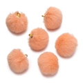 Detail view of soft orange faux mink fur pom-poms with golden metal rings for DIY jewelry - Orange