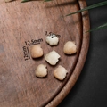 Detailed view of hand-carved Bodhi root beads in warm lotus and hand shapes for DIY jewelry - Nine-Tailed Fox Style Medium