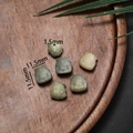 Macro detail of hand-carved cat-shaped bodhi root beads with 11.5mm size measurement - Nine-Tailed Fox Style Small
