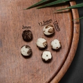 Macro detail of 12mm hand-carved lotus root beads for DIY jewelry with 2mm hole size - Style 07 Vintage Textured Bead (11.5*12mm)