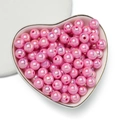 Close-up of pink acrylic AB luster round beads for DIY jewelry in a heart tray - 6mm (100 Pieces/Pack) / Hot Pink
