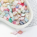 Macro shot of colorful diamond-shaped shell beads for DIY jewelry in a white tray - Flat Rhombus Style (AC4106) / 1 Strand (approx. 27 pcs, 10x15mm)