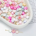 Macro detail of colorful shell flower beads in white ceramic bowl for DIY jewelry - Five-Petal Flower Style (AC4106) / 1 Strand (approx. 48 pcs, 9x9mm)