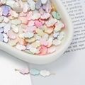 Macro shot of colorful shell Hamsa beads in a white bowl for DIY jewelry making - Hamsa Hand Style 2 (AC4103) / 1 Strand (approx. 34 pcs, 8.5x12mm)
