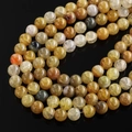 Macro shot of natural dragon vein agate beads with translucent texture for DIY jewelry - 6.5mm (Approx. 67 Pcs/Strand) / Amber Dragon Vein Agate