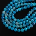 Macro shot of blue dragon vein agate beads with detailed ice crackle texture on black background - 6.5mm (Approx. 67 Pcs/Strand) / Lake Blue Dragon Vein Agate