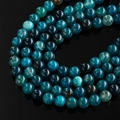 Macro shot of polished dragon vein agate beads with unique blue crackle pattern - Peacock Green Dragon Vein Agate