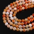 Macro view of polished dragon vein agate beads with cracked texture in red and orange - Natural Red Agate