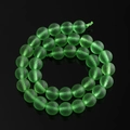 Macro shot of green frosted glass beads with matte texture on black reflective surface - 6mm (Approx. 72 Beads/Strand) / Green