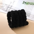 Close-up of black 2cm thick plush chenille stem with dense curly coral fleece texture - Black
