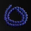 Detail view of 10mm frosted dark blue glass beads with textured matte finish for DIY jewelry - Sapphire Blue