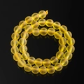 Macro shot of yellow translucent Czech glass beads with natural matte textured finish - Yellow