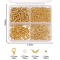 Detailed view of golden lobster clasps, jump rings and crimp beads in a plastic storage box - Gold